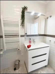 a white bathroom with a sink and a mirror at R-15 Rincón del Sol in Torrevieja