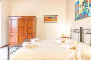 a bedroom with a bed and a wooden cabinet at La Terrazza Felice - in centro a Perugia in Perugia