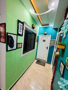 a hallway with green and blue walls and a door at Moven Inn Hotel Islamabad in Islamabad
