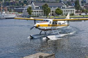 a yellow and white plane is on the water at Silver Cloud Hotel - Seattle Lake Union in Seattle