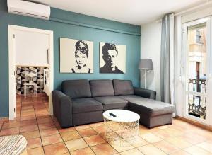 a living room with a couch and a table at Flats Friends Nave in Valencia