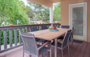 a wooden table and chairs on a deck at Villa Sitges Mas Mestre in Viladellops