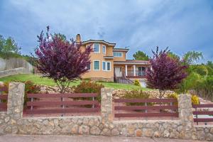 a large house with a fence in front of it at Villa Sitges Mas Mestre in Viladellops