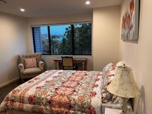a bedroom with a bed and a large window at Brand New & Central - 3 Bedrooms with 3 En suites in Auckland