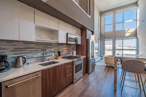 a kitchen with a sink and a stove top oven at Luxury 3 Bedroom 2 Bath Loft! Beautiful Views in Los Angeles