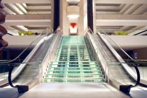 an escalator in a building with green stairs at Hyatt Regency O'Hare Chicago in Rosemont