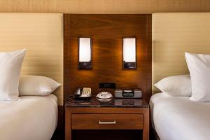 a hotel room with two beds and a telephone at Hyatt Regency O'Hare Chicago in Rosemont