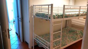 two bunk beds in a room with a hallway at Casetta Gialla in Lerici
