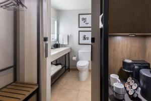 a small bathroom with a toilet and a sink at Hyatt Regency O'Hare Chicago in Rosemont