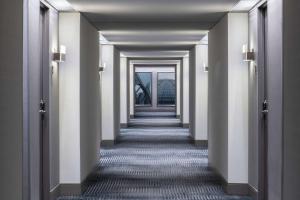 a corridor of a building with white walls and columns at Hyatt Regency O'Hare Chicago in Rosemont
