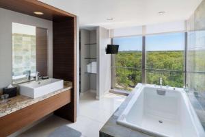 a bathroom with a large tub and a large window at Hyatt Regency O'Hare Chicago in Rosemont