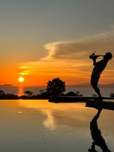 a statue of a person standing next to a body of water at Nakabalo Guesthouse & Restaurant in Siquijor