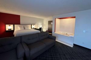 a hotel room with a bed and a couch at Ramada by Wyndham Waupaca in Waupaca
