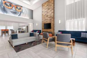 a living room with a couch and chairs at La Quinta by Wyndham Ft. Pierce in Fort Pierce