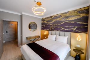 Postel nebo postele na pokoji v ubytování Elitte Inn & Suites