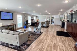 a living room with couches and a flat screen tv at Quality Inn Gainesville I-75 in Gainesville