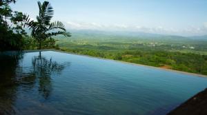 a swimming pool with a view of a valley at Dorala Villa-Your home away home in Kuruwita