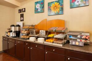 a counter with a bunch of food on it at Hotel Marguerite South Anaheim - Garden Grove, Trademark Collection by Wyndham in Anaheim