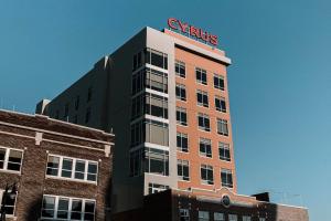 a tall building with a sign on top of it at Cyrus Hotel, Topeka, a Tribute Portfolio Hotel in Topeka