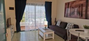 a living room with a couch and a table at Parque don Jose apartment in Costa Del Silencio
