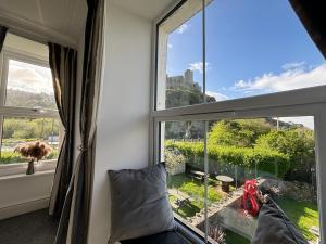 a room with a window with a view of a garden at The Queens Hotel Harlech in Harlech