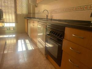A kitchen or kitchenette at Delfines II Solo Familias Serviplaya