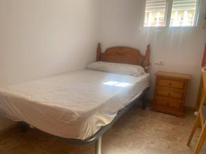 A bed or beds in a room at Delfines II Solo Familias Serviplaya