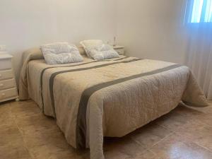 A bed or beds in a room at Delfines II Solo Familias Serviplaya