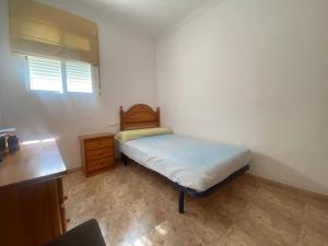 A bed or beds in a room at Delfines II Solo Familias Serviplaya
