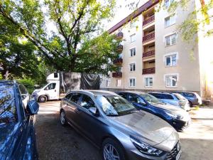 a group of cars parked in a parking lot at Symple apartments in Košice