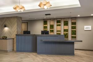 an office lobby with a reception desk and windows at Fairfield by Marriott Inn & Suites Fresno Riverpark in Fresno