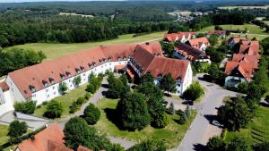 an aerial view of a large building with red roofs at Gut Matheshof Apartments in Rieden