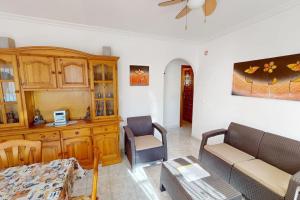 a living room with a couch and a table at Casa 1227 in Los Alcázares