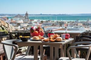 uma mesa com pão e fruta em cima de uma varanda em Lagos Uptown Bed & Breakfast em Lagos