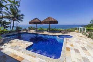 a swimming pool with a view of the ocean at Pousada Recanto de Paraty in Paraty