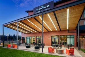 awning on the front of a building with tables and chairs at The Hoffmann Hotel Basalt Aspen Tapestry Collection Hilton in Basalt