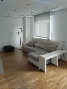 a living room with a couch and a window at bonito piso zonas 1'5 del centro in Pamplona