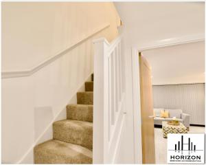 a staircase in a room with a living room at Central Durham - Luxury Hideout - Free Parking in Durham