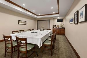 a large dining room with a white table and chairs at Country Inn & Suites by Radisson, Appleton North, WI in Little Chute