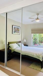 a bedroom with a bed with sliding glass doors at COMFORT QUEEN GARDEN VIEW ROOM MACQUARIE PARK RYDE in Sydney