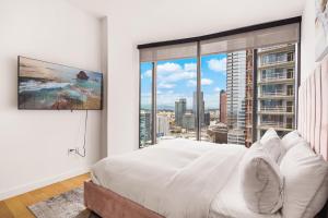 a bedroom with a white bed and a large window at 3 Bed 3 Bath Penthouse at Prime Location in Los Angeles