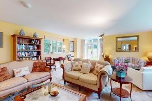 a living room with couches and a table at The Wool Barn Simonsbath in Exford