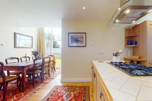 a kitchen with a table and a dining room at The Wool Barn Simonsbath in Exford