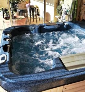 a large jacuzzi tub with water in it at Villa Angel - SPA in Caunes-Minervois