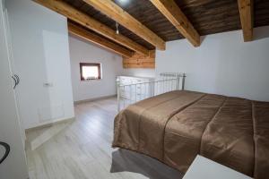 a bedroom with a bed in a room with wooden ceilings at Roberta House in Isernia