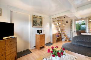 a living room with a couch and a television at Ferienhaus Bruhn in Flensburg