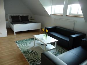 - un salon avec un canapé et une table dans l'établissement Gasthof Ziegelhof, à Eichenwinden