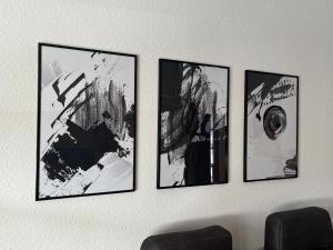 four pictures are hanging on a wall at Ferienwohnung TAUNUSIDYLLE 
