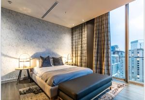 a bedroom with a bed and a large window at The RoyalPlatinum Penthouse in Johannesburg +21 photos