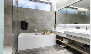 a bathroom with two sinks and a large mirror at The RoyalPlatinum Penthouse in Johannesburg